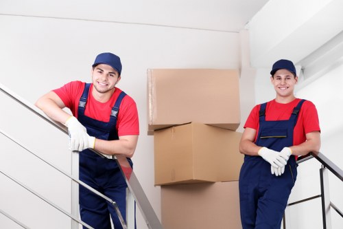 Professional movers handling flat removals in Hampton outside a modern apartment building