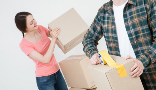 Moving day in Hampton with house removal van and neatly arranged household boxes