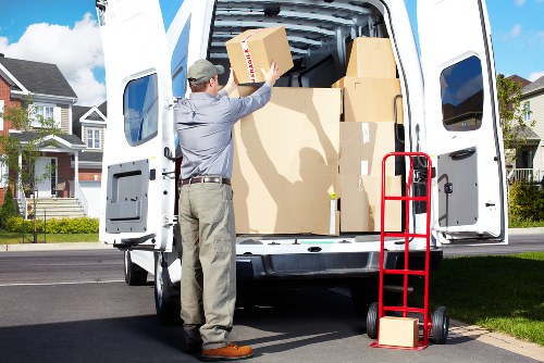 Professional movers handling boxes and furniture for a small removal