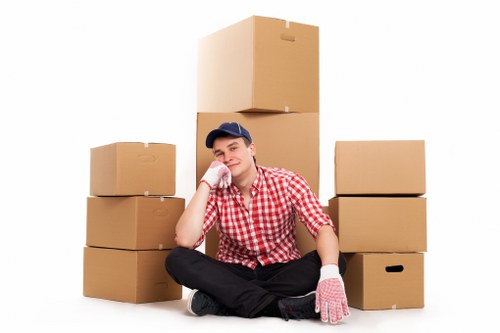 Movers carrying furniture through a Hampton apartment block during a flat removal